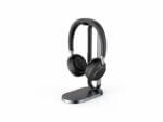 Wireless headphones on stand, white background.