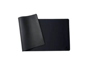 Black desk mat with leather flap on white background.